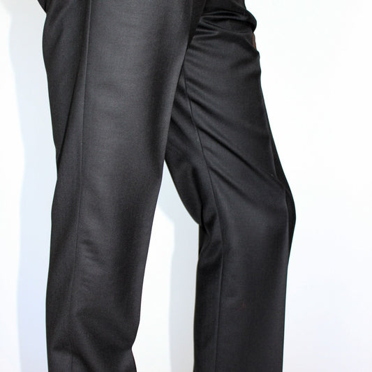 High-waisted tapered trousers by COLUCCI, expertly crafted by a Savile Row tailor from luxurious superfine merino wool with natural stretch. Featuring side adjusters for a perfect fit and a versatile jet-black hue, suitable for both office and casual wear.