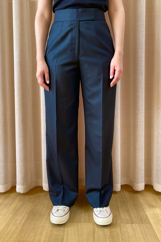 High-waisted wide-leg trousers by COLUCCI, expertly crafted by a Savile Row tailor from luxurious superfine merino wool with natural stretch. The jet-black hue ensures versatility, perfect for pairing with a crisp shirt, chunky knit, or silky top for various occasions. A refined staple combining classic tailoring with modern sophistication.