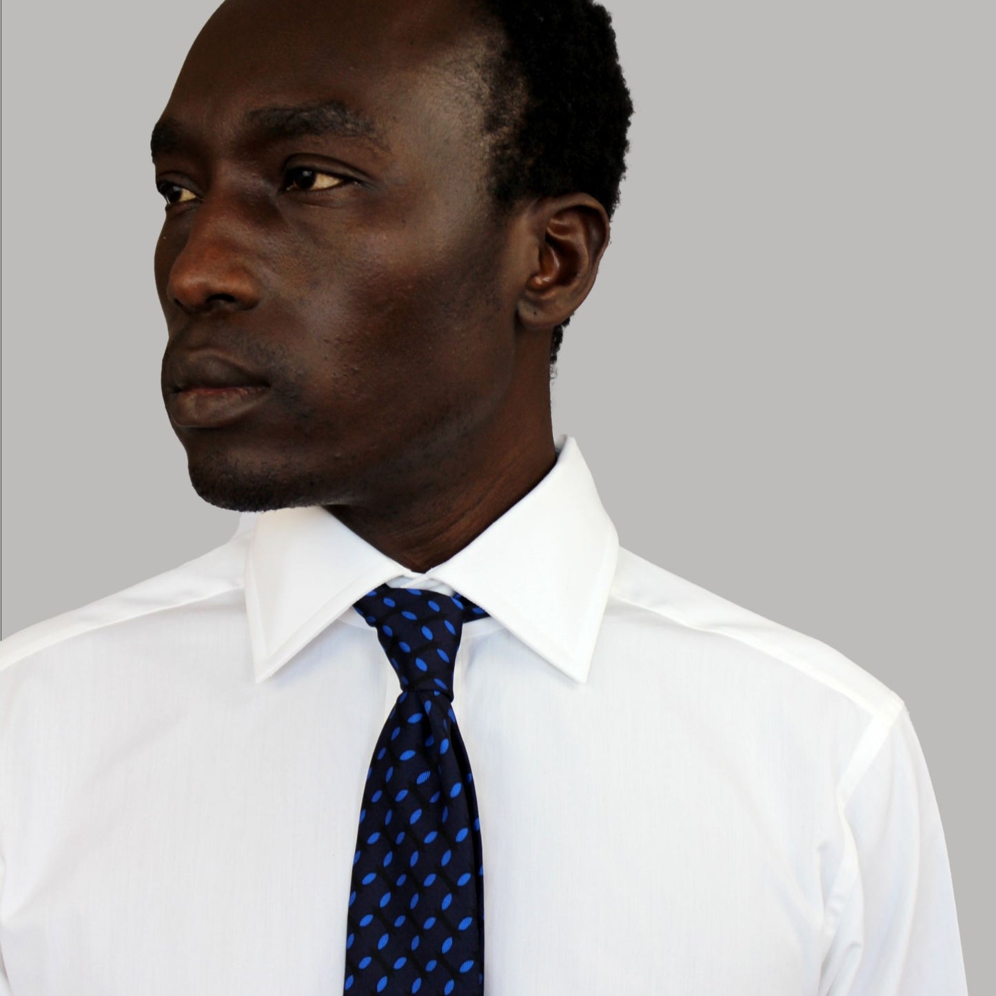 Navy and blue silk slim blade tie by COLUCCI, crafted in Macclesfield from 100% premium silk and hand-finished by expert tie specialists. Produced in limited runs, offering unique sophistication and reflecting a commitment to sustainable fashion and exceptional craftsmanship.