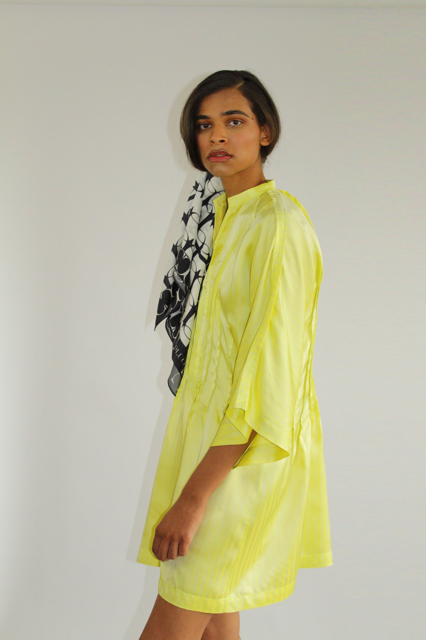 Yellow tunic dress by COLUCCI, crafted from luxurious discontinued deadstock fabrics for a one-of-a-kind, limited edition piece. Made-to-order in our London studio with kimono-inspired sleeves and a pin-tuck waist, this dress offers timeless style and impeccable design, destined to be a cherished wardrobe staple.