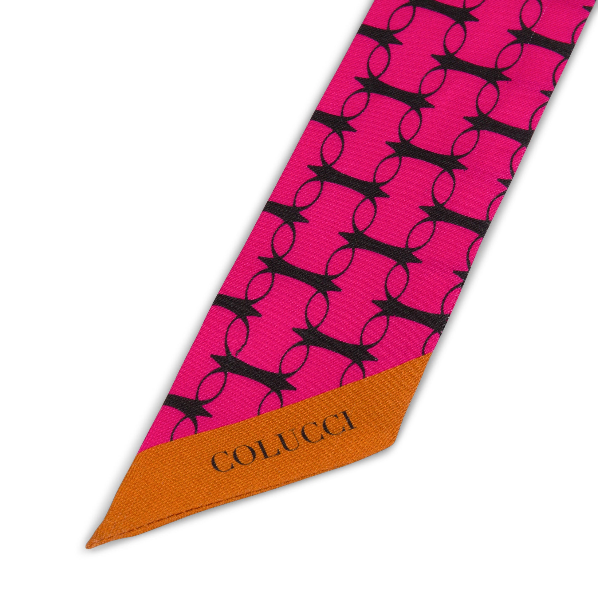 Pink and orange monogram silk twilly by COLUCCI, meticulously printed in Macclesfield. This limited-edition scarf offers unique luxury and reflects a commitment to sustainable fashion, perfect for elegantly tying around your neck or adding sophistication to your bag.