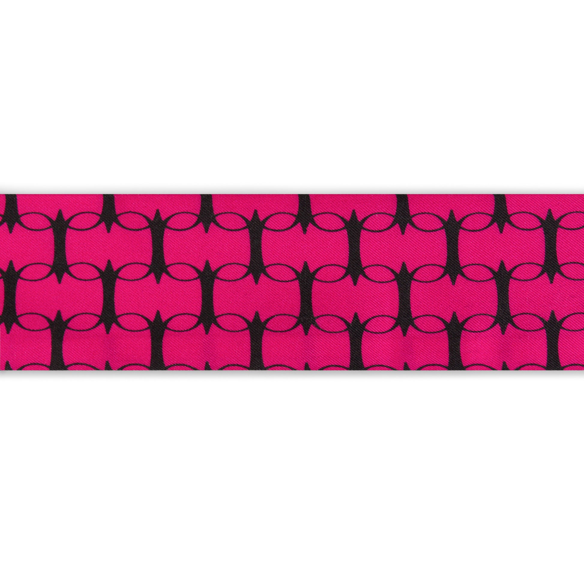 Pink and orange monogram silk twilly by COLUCCI, meticulously printed in Macclesfield. This limited-edition scarf offers unique luxury and reflects a commitment to sustainable fashion, perfect for elegantly tying around your neck or adding sophistication to your bag.