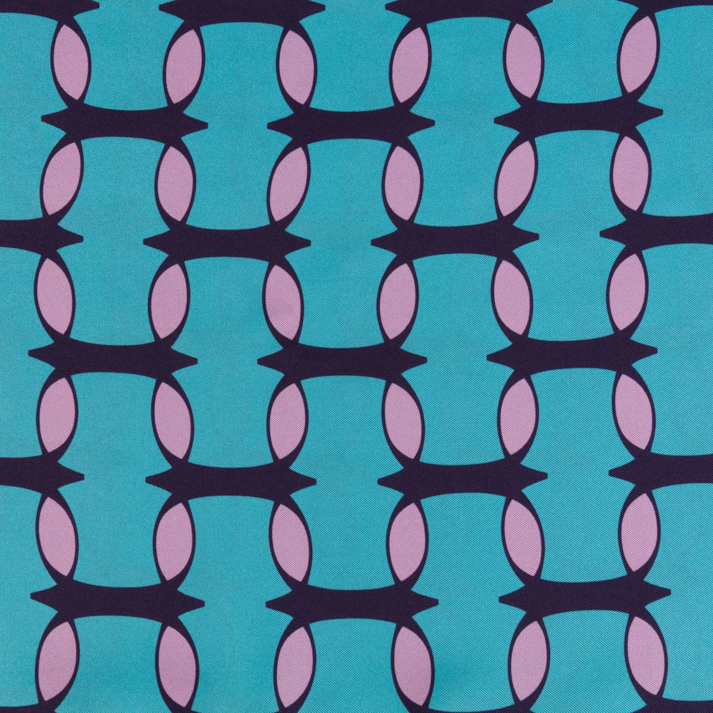 Teal and pink monogram silk shawl by COLUCCI, hand-rolled and printed in Macclesfield. This extra-long, limited-edition shawl offers versatile styling and a touch of drama, reflecting a commitment to sustainable fashion with minimized overproduction.