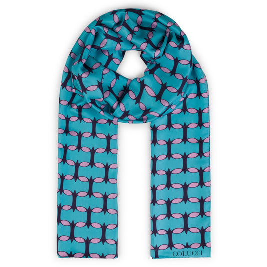Teal and pink monogram silk shawl by COLUCCI, hand-rolled and printed in Macclesfield. This extra-long, limited-edition shawl offers versatile styling and a touch of drama, reflecting a commitment to sustainable fashion with minimized overproduction.